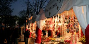 A woman standing in front of a market stall at night
